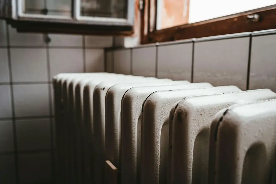 A row of cast iron radiator columns under a window