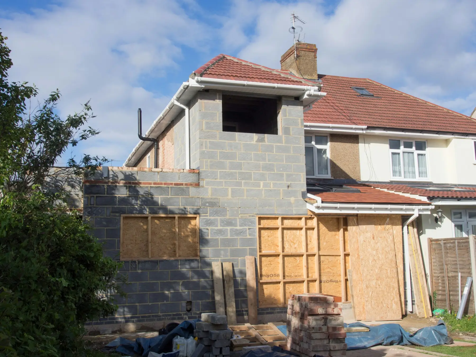 A two-storey blockwork side extension on a semi-detached house