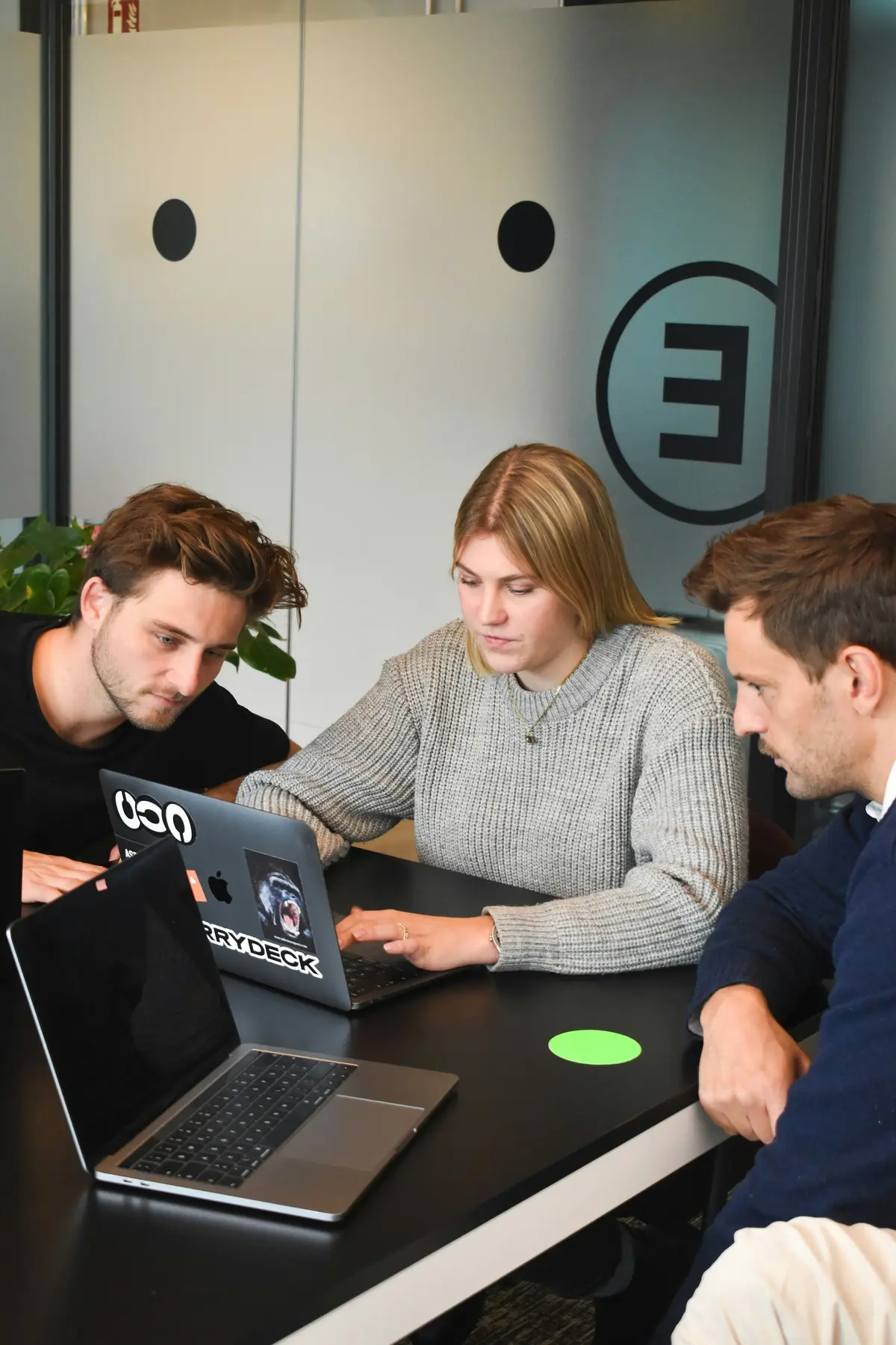 Three designers looking at a laptop together