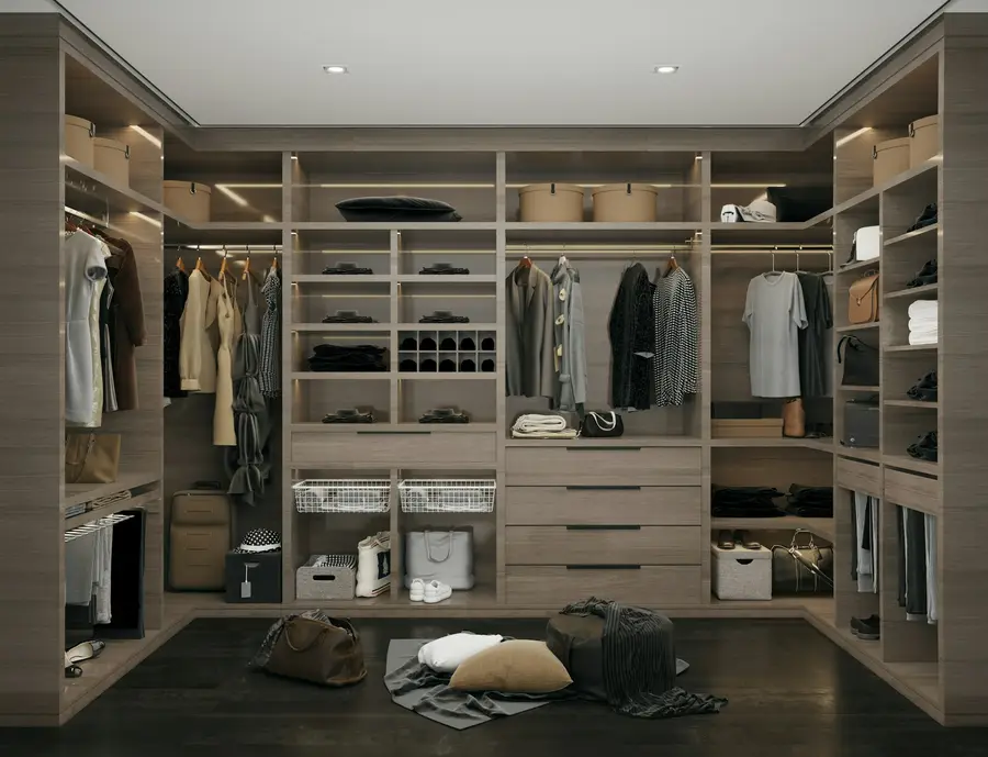A walk-in dressing room with shelves, rails and drawers