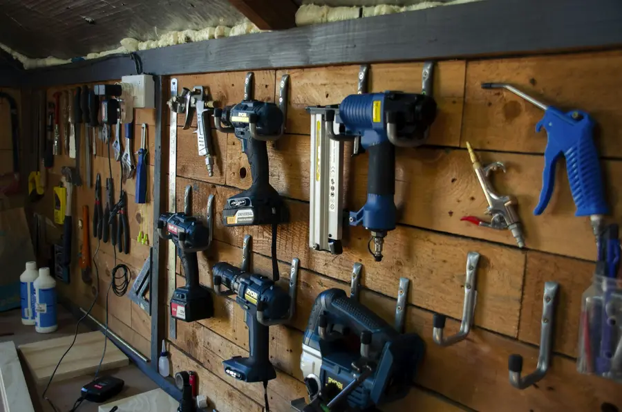 Power tools hanging on a workshop wall