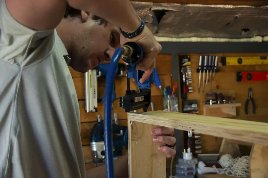 A joiner fixing a timber carcass in the workshop
