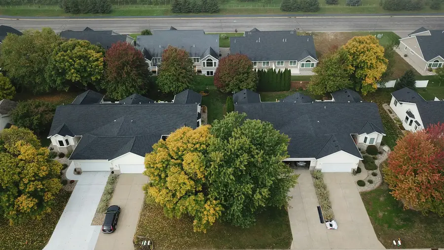 Aerial view of a street of houses with dark roofs